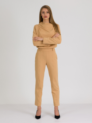 woman with blond hair wearing brown organic cotton elegant blouse and brown organic cotton long tapered leg pants