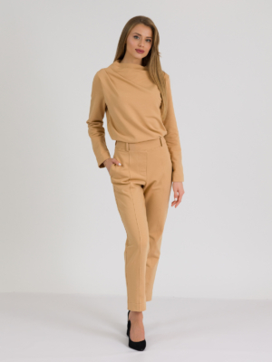 woman with blond hair wearing brown organic cotton elegant blouse and brown organic cotton long tapered leg pants