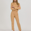 woman with blond hair wearing brown organic cotton elegant blouse and brown organic cotton long tapered leg pants