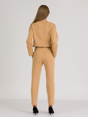 woman with blond hair wearing brown organic cotton elegant blouse and brown organic cotton long tapered leg pants