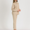 woman with blond hair wearing beige organic cotton oversized polo collar sweatshirt and beige organic cotton long tapered leg pants