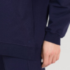 woman with blond hair wearing dark blue organic cotton oversized polo collar sweatshirt and dark blue organic cotton long wide pants