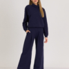 Woman with blond hair wearing organic cotton dark blue color hoodie and dark blue color long wide pants