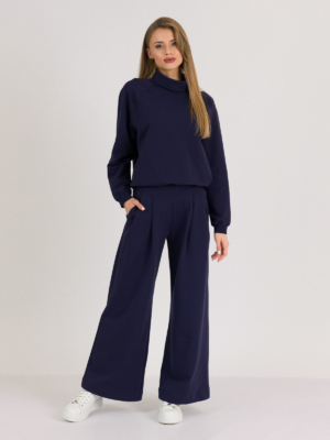 Woman with blond hair wearing organic cotton dark blue color hoodie and dark blue color long wide pants
