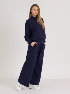 Woman with blond hair wearing organic cotton dark blue color hoodie and dark blue color long wide pants