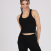 Women with brown hair is wearing black organic cotton tank top and black organic cotton leggings