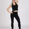 Women with brown hair is wearing black organic cotton tank top and black organic cotton leggings