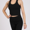Women with brown hair is wearing black organic cotton tank top and black organic cotton leggings