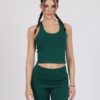 Women with brown hair is wearing dark green organic cotton tank top and dark green organic cotton leggings