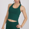 Women with brown hair is wearing dark green organic cotton tank top and dark green organic cotton leggings