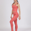 Women with brown hair is wearing pink organic cotton tank top and pink organic cotton leggings