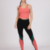 Women with brown hair is wearing pink organic cotton tank top and multicolored organic cotton leggings