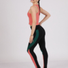 Women with brown hair is wearing pink organic cotton tank top and multicolored organic cotton leggings