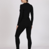 Women with brown hair is wearing black organic cotton long sleeve top and black organic cotton leggings