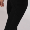 Women with brown hair is wearing black organic cotton long sleeve top and black organic cotton leggings