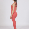 Women with brown hair is wearing pink organic cotton tank top and pink organic cotton leggings
