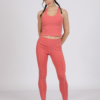 Women with brown hair is wearing pink organic cotton tank top and pink organic cotton leggings