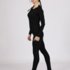 Women with brown hair is wearing black organic cotton long sleeve top and black organic cotton leggings