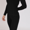 Women with brown hair is wearing black organic cotton long sleeve top and black organic cotton leggings
