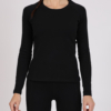 Women with brown hair is wearing black organic cotton long sleeve top and black organic cotton leggings