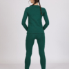 Women with brown hair is wearing dark green organic cotton long sleeve top and dark green organic cotton leggings