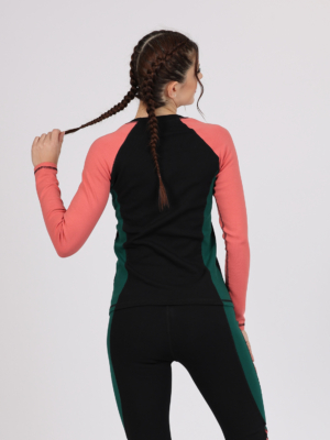 Women with brown hair is wearing multicolored organic cotton long sleeve top and multicolored organic cotton leggings
