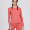 Women with brown hair is wearing pink organic cotton long sleeve top and pink organic cotton leggings