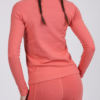 Women with brown hair is wearing pink organic cotton long sleeve top and pink organic cotton leggings