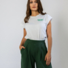 Woman wearing dark green organic cotton pants and white organic cotton t-shirt with embroidery "proud outfit reperater
