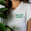 Woman wearing white organic cotton t-shirt with embroidery "proud outfit reperater