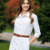Woman wearing white organic cotton shirt dress with bracelet sleeves coconut buttons and waist belt