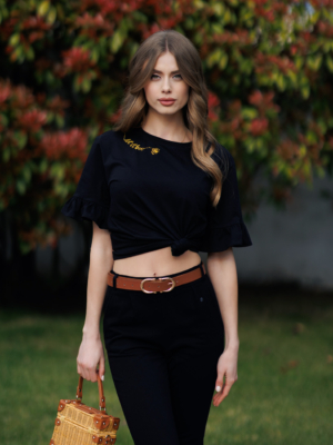 Woman wearing black organic cotton pants and black organic cotton t-shirt with embroidery "Let it bee"