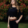 Woman wearing black organic cotton pants and black organic cotton t-shirt with embroidery "Let it bee"