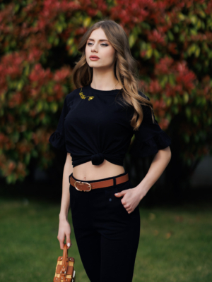 Woman wearing black organic cotton pants and black organic cotton t-shirt with embroidery "Let it bee"