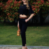 Woman wearing black organic cotton pants and black organic cotton t-shirt with embroidery "Let it bee"