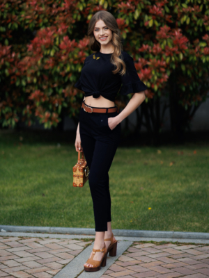 Woman wearing black organic cotton pants and black organic cotton t-shirt with embroidery "Let it bee"