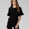 Woman wearing black organic cotton pants and black organic cotton t-shirt with embroidery "Let it bee"