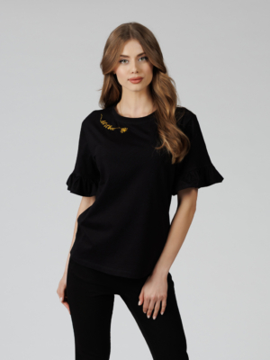 Woman wearing black organic cotton pants and black organic cotton t-shirt with embroidery "Let it bee"