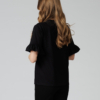 Woman wearing black organic cotton pants and black organic cotton t-shirt with embroidery "Let it bee"