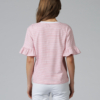 Woman wearing white organic cotton pants and pink striped organic cotton t-shirt with embroidery "Less is more"