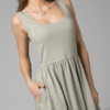 Woman wearing gray organic cotton dress with a flared skirt, midi length, square neckline, high waist and pockets.