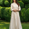 Dark-haired woman wearing a long linen dress with coconut buttons and collar