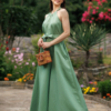 Dark-haired woman wearing a green jumpsuit with wide legs made of lyocell and linen