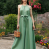 Dark-haired woman wearing a green jumpsuit with wide legs made of lyocell and linen