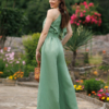 Dark-haired woman wearing a green jumpsuit with wide legs made of lyocell and linen