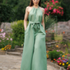 Dark-haired woman wearing a green jumpsuit with wide legs made of lyocell and linen