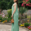 Dark-haired woman wearing a green jumpsuit with wide legs made of lyocell and linen