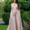 Dark-haired woman wearing a pink jumpsuit with wide legs made of lyocell and linen