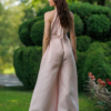 Dark-haired woman wearing a pink jumpsuit with wide legs made of lyocell and linen