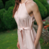 Dark-haired woman wearing a pink jumpsuit with wide legs made of lyocell and linen